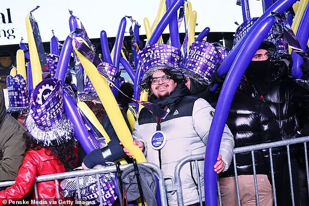 Glowing in the Cold: Times Square Revelers Celebrate New Year's Eve with Novelty Glasses and Unyielding Spirit