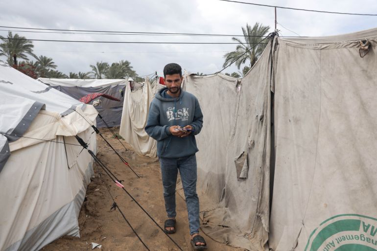 Gazans rely on phone torches for light after war destroys power grid.